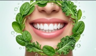 Conceptual human smile encircled by fresh spinach and kale leaves representing dietary blueprint for strong teeth