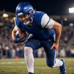 Hamstring injury recovery: NFL quarterback grabbing back of thigh after hamstring tear during game
