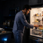 Late night eating — person snacking at midnight, a habit linked to higher fatty liver disease risk